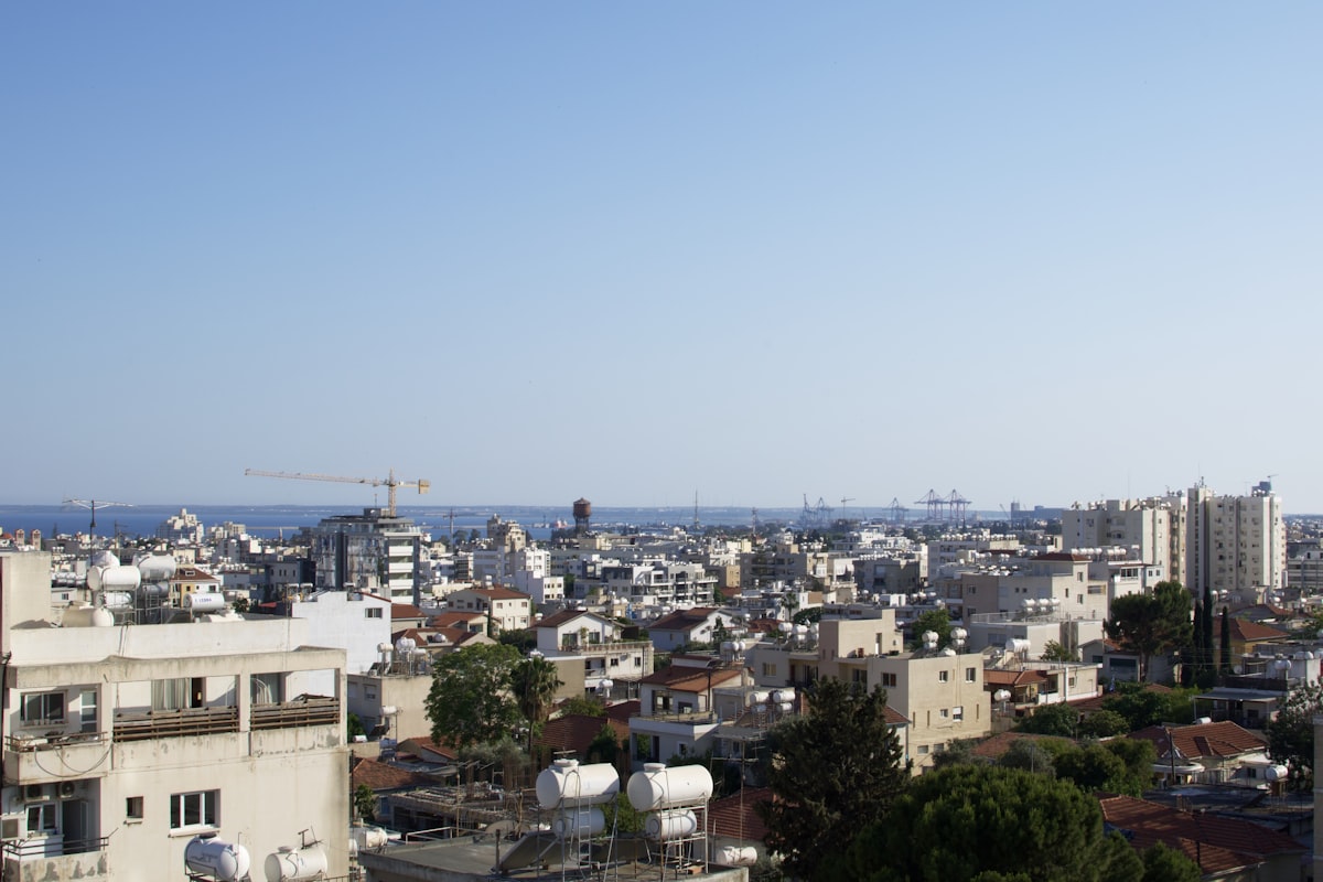 Rooftops in Limassol, Cyprus, with construction cranes on the skyline