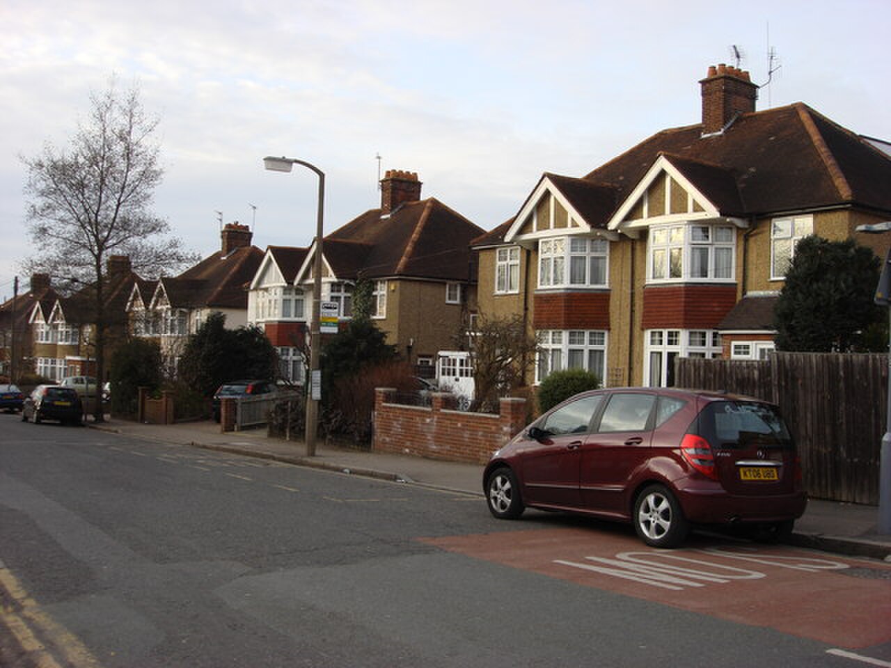 A street of typical 1930s English suburban detached and semi-detached houses