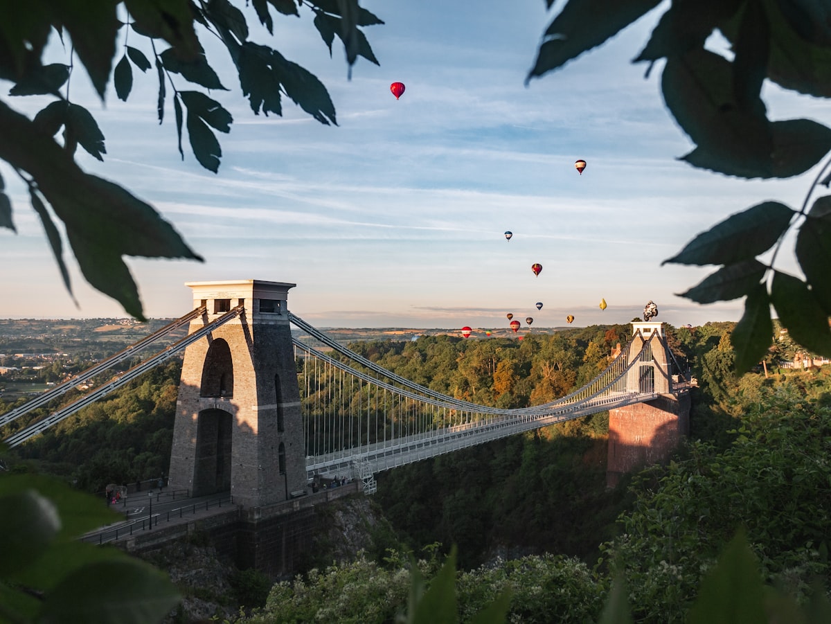 Clifton Suspension Bridge in Bristol with hot air balloons overhead