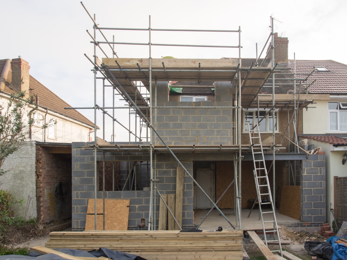 Scaffolding around a semi-detached house during building work in England